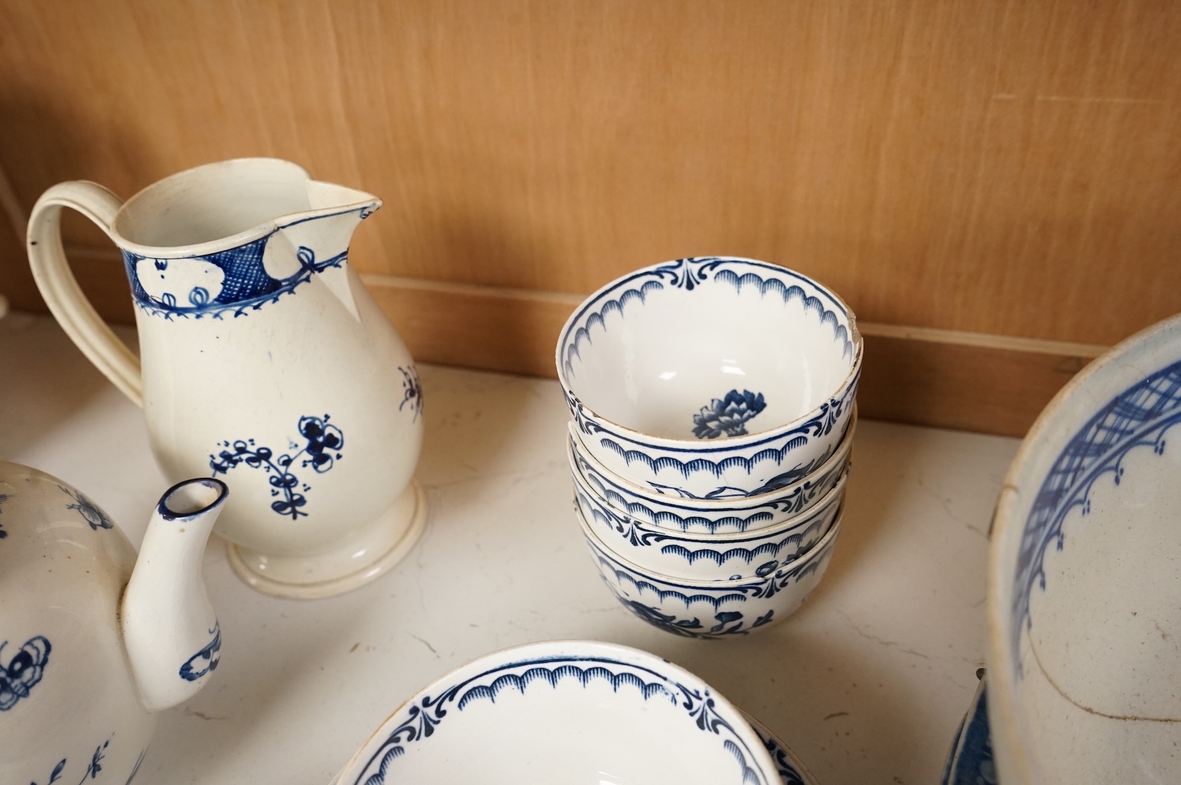 An 18th century blue and white Worcester jug and assorted Booths Worcester style tea wares, largest 24cm high